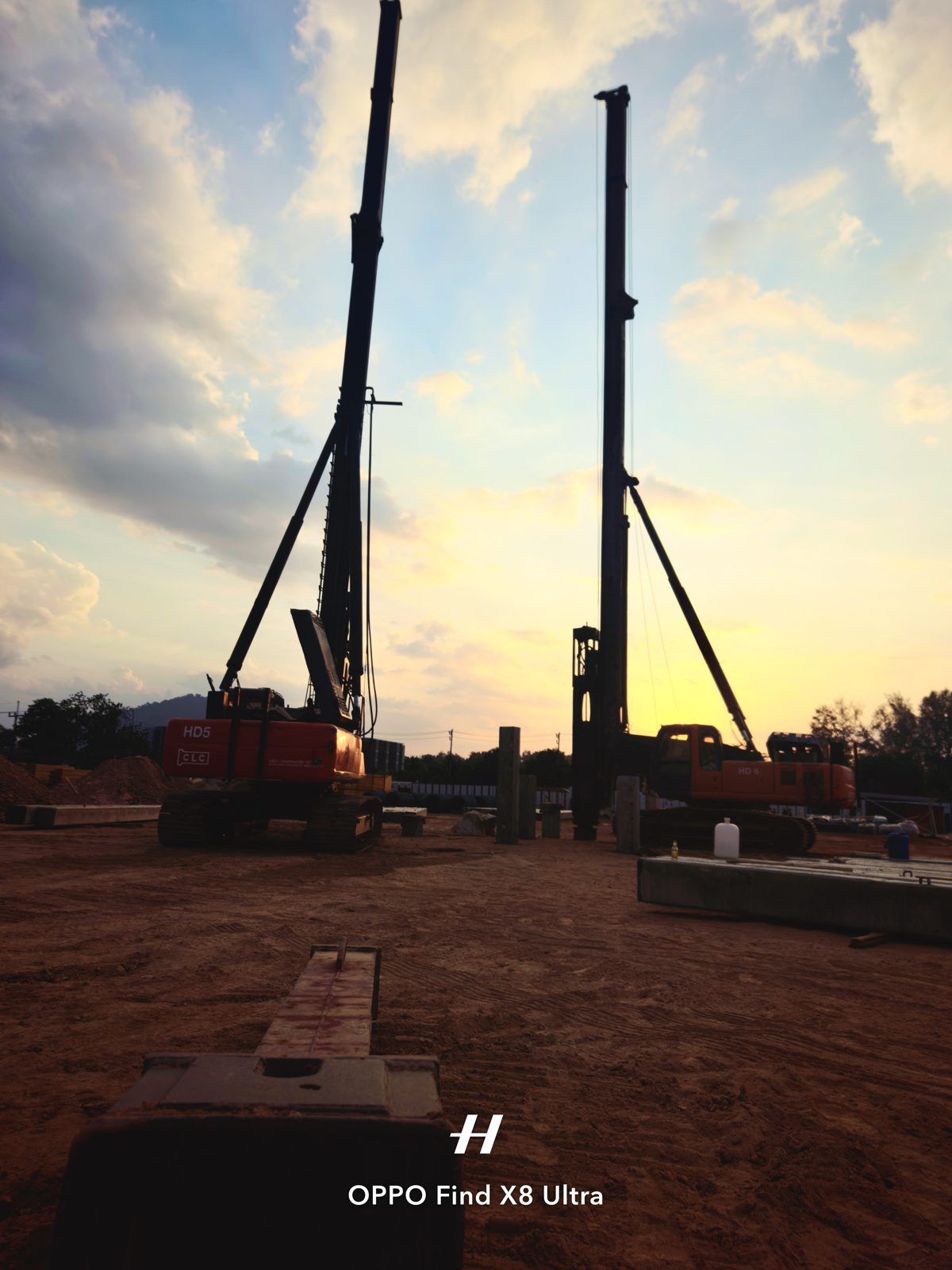 Royal Lee Turquoise, Phuket. Photo taken 2026-02-02. Two piling rigs operating on site; concrete foundation elements in the foreground.